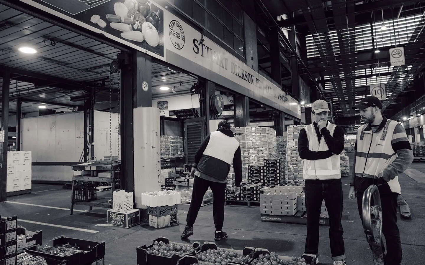 Storefront of Stuart Dickson Produce at the Sydney Wholesale Markets, showcasing fresh produce and a bustling market environment. An excellent example of using professional photography to enhance a Google Business Profile, improve local SEO, and attract customers looking for quality wholesale produce.